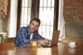 Businessman or student working with laptop computer at coffee shop having breakfast Royalty Free Stock Photo