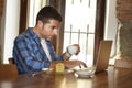 Businessman or student working with laptop computer at coffee shop having breakfast Royalty Free Stock Photo