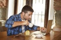Businessman or student working with laptop computer at coffee shop having breakfast Royalty Free Stock Photo