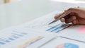 Businessman studying statistics and analyzing pens and graphing documents on a desk with a laptop and a calculator Royalty Free Stock Photo