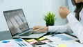 Businessman studying statistics and analyzing pens and graphing documents on a desk with a laptop and a calculator Royalty Free Stock Photo