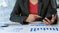 Businessman studying statistics and analyzing pens and graphing documents on a desk with a laptop and a calculator Royalty Free Stock Photo