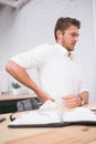 Businessman suffering from backache at office desk Royalty Free Stock Photo