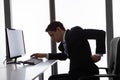 Businessman suffering from backache in office