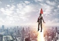 Businessman in aviator hat flying on rocket