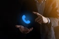 Businessman in suit on black background clicks on phone icon.Call Now Business Communication Support Center Customer Service