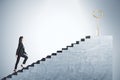 Businessman in suit climbing stairs with golden key Royalty Free Stock Photo