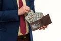 Businessman in suit gets us money from the wallet, isolated. Male hands holding a black leather wallet with US Dollars cash inside Royalty Free Stock Photo