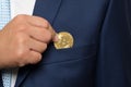Businessman in suit holding a golden bit-coin Royalty Free Stock Photo