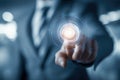 Businessman in suit interacting with futuristic glowing digital interface representing technology innovation and virtual touch Royalty Free Stock Photo