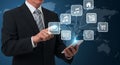 Professional Man Engaging with Digital Icons on Tablet Representing Global Business Applications Royalty Free Stock Photo