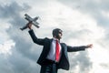 businessman in suit and pilot hat launch plane toy. boost idea