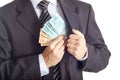 Businessman in a suit putting money in his pocket Royalty Free Stock Photo