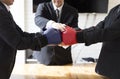 Businessman in suit with red and blue boxing gloves Royalty Free Stock Photo