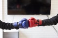 Businessman in suit with red and blue boxing gloves Royalty Free Stock Photo