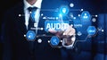 Businessman in Suit Selecting Audit Icon on Digital Screen with Innovative Technology and Data Analysis for Corporate Royalty Free Stock Photo