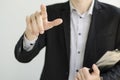 Businessman in suit showing something with pen.