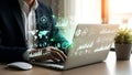 Man working on laptop with holographic data interface showcasing business analytics and insights for strategic decisions Royalty Free Stock Photo