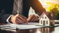 Businessman in a suit signing a home loan contract. AI Generated