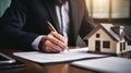 Businessman in a suit signing a home loan contract. AI Generated