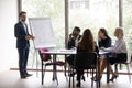 Businessman makes presentation for investors during group meeting in boardroom Royalty Free Stock Photo