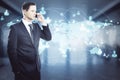 Businessman in a suit talking on the phone with a world map with rays in the background. International and worldwide trade concept Royalty Free Stock Photo