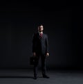 Businessman in a suit and tie on a black background Royalty Free Stock Photo