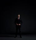 Businessman in suit and tie. Black background with copyspace. Royalty Free Stock Photo