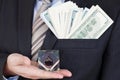 Businessman in suit, tie holds in hands drop of black oil of Brent brand in crystal cube.Pack of hundred dollars bills.Crisis in