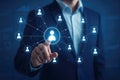 Businessman interacts with a glowing digital network of people icons and data charts technology connection Royalty Free Stock Photo