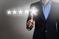 Businessman in a suit touching screen five star symbol 5 rating with a concept about positive customer feedback and review,