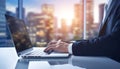 a businessman in a suit typing on a laptop, corporate sunset cityscape views in the background