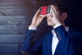 Businessman in suit uses a colorful virtual reality glasses