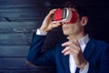 Businessman in suit uses a colorful virtual reality glasses