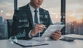 Businessman in suit using tablet with holographic financial charts and data interface, modern analytics dashboard, fintech, Royalty Free Stock Photo