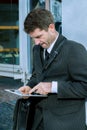 Businessman in suit using tablet PC