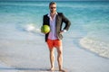 Businessman in suit with watermelon in sea. business man on summer vacation. businessman in wet suit at the beach