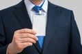 Businessman in suit wearing a blank ID tag or name card on a lanyard at an exhibition or conference Royalty Free Stock Photo