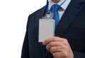 Businessman in suit wearing a blank ID tag or name card on a lanyard at an exhibition or conference