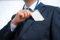 Businessman in suit wearing a blank ID tag or name card on a lanyard at an exhibition or conference Royalty Free Stock Photo