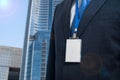 Businessman in suit wearing a blank ID tag or name card on a lanyard at an exhibition or conference Royalty Free Stock Photo