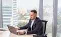 Businessman in suit working on laptop