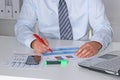 Businessman in suit working on laptop, at a table in the office