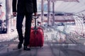 Businessman and suitcase in the airport departure lounge, with a travel concept,summer vacation concept, traveler suitcases in air