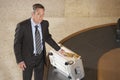 Businessman With Suitcase At Luggage Carousel In Airport Royalty Free Stock Photo