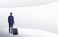 Businessman with suitcase walking in waiting room Royalty Free Stock Photo