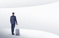 Businessman with suitcase walking in waiting room Royalty Free Stock Photo