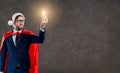 A businessman in a superhero Santa costume with a light bulb in