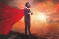 Businessman superheroes wearing red hero cape and gas mask Standing cross her arms,background of city covered by world is shield