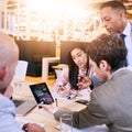 Businessman supervising his employees as they brainstorm and work together Royalty Free Stock Photo